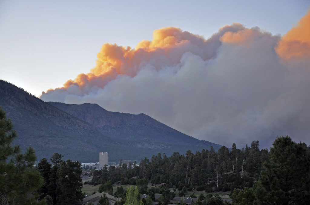 Smoke from the Schultz Fire rises as the sun sets for the day. Taken 6/20/10 by Brady Smith. Credit: USDA Forest Service, Coconino National Forest.