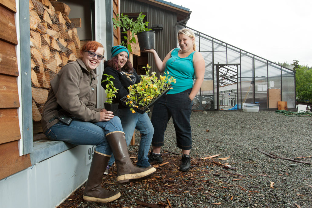 Students on Prince of Wales Island show off vegetable starts grown in wood-fired greenhouse.